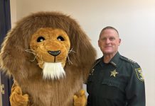 The Landrum Middle School mascot joins St. Johns County Sheriff Hardwick during the inaugural Lion Fest, which featured a safety talk and community pep rally. Photo courtesy Landrum Middle School PTO