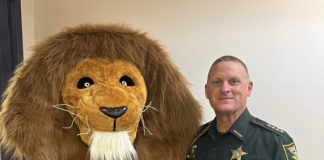The Landrum Middle School mascot joins St. Johns County Sheriff Hardwick during the inaugural Lion Fest, which featured a safety talk and community pep rally. Photo courtesy Landrum Middle School PTO
