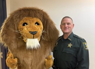 The Landrum Middle School mascot joins St. Johns County Sheriff Hardwick during the inaugural Lion Fest, which featured a safety talk and community pep rally. Photo courtesy Landrum Middle School PTO