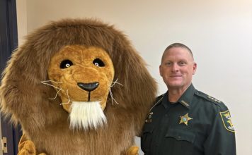 Landrum Roars into Spring with Inaugural Lion Fest The Landrum Middle School mascot joins St. Johns County Sheriff Hardwick during the inaugural Lion Fest, which featured a safety talk and community pep rally. Photo courtesy Landrum Middle School PTO