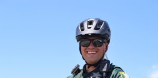 Cpl. Michael Ettel displays the St. Johns County Sheriff’s Office e-bike safety card, which outlines the differences between electric bicycle classes and illegal e-motos. Photo courtesy St. Johns County Sheriff's Office