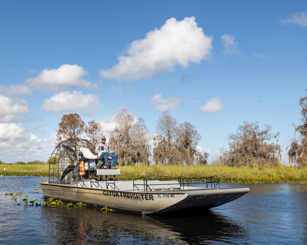 An airboat skims through the headwaters of the Everglades during a Boggy Creek Airboat ride. Photo courtesy of Debi Lander.