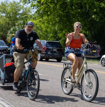 First-ever Duval Day Bike Tour inspires riders to explore Jacksonville’s Northside Cyclists wave to onlookers as they ride together during the Duval Day Bike Tour. Photo by Emily Delaney