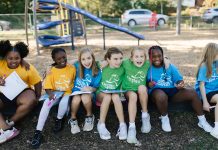 Girls on the Run teammates sit together during a program session at the park. Photo courtesy Girls on the Run