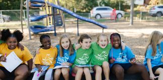 Girls on the Run teammates sit together during a program session at the park. Photo courtesy Girls on the Run