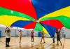 Students in the Williams Family YMCA's Homeschool PE program play a parachute game together. Photo by Emily Delaney