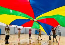 Students in the Williams Family YMCA's Homeschool PE program play a parachute game together. Photo by Emily Delaney
