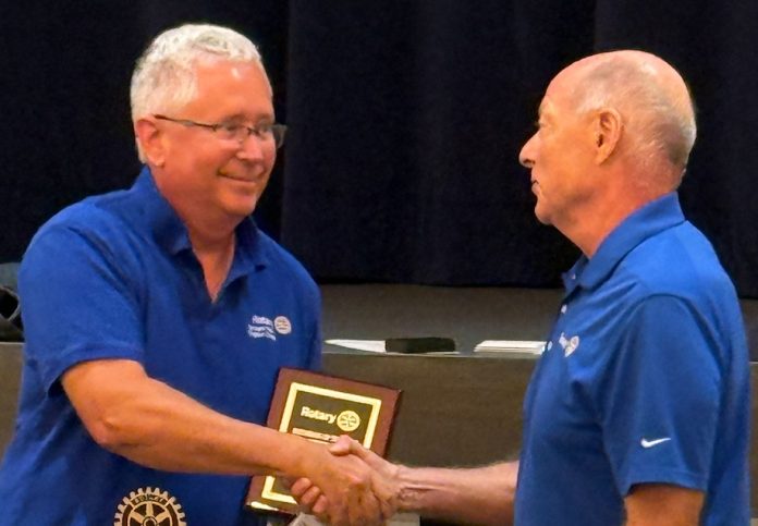 Jamie Mackey, left, receives the Rotarian of the Year award from 2005-06 Club President Mitch Ross. Photo courtesy Rotary Club of Bartram Trail - Julington Creek