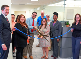 From left, Clerk Brandon Patty, Deputy Clerk Randy Beck, Recording Supervisor Kimberly Jarrell, Minutes & Records Director Matt Shuler, Deputy Clerk Adam Ehrenberg, Recording Director Kati Smith, Deputy Clerk Connie Logan, Deputy Clerk Zhane Brown and Master Clerk Rita Rios cut the ribbon on the new Public Service Center Monday, Aug. 3, 2026. Photo courtesy of St. Johns County Clerk of the Circuit Court and County Comptroller's Office
