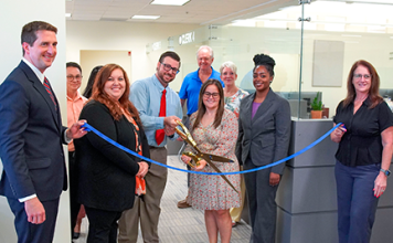 From left, Clerk Brandon Patty, Deputy Clerk Randy Beck, Recording Supervisor Kimberly Jarrell, Minutes & Records Director Matt Shuler, Deputy Clerk Adam Ehrenberg, Recording Director Kati Smith, Deputy Clerk Connie Logan, Deputy Clerk Zhane Brown and Master Clerk Rita Rios cut the ribbon on the new Public Service Center Monday, Aug. 3, 2026. Photo courtesy of St. Johns County Clerk of the Circuit Court and County Comptroller's Office