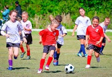 Young athletes compete during a First Coast YMCA youth soccer match. Photo courtesy of First Coast YMCA