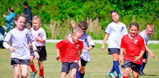 Young athletes compete during a First Coast YMCA youth soccer match. Photo courtesy of First Coast YMCA
