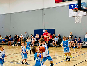Young athletes compete during a First Coast YMCA youth basketball game. Photo courtesy of First Coast YMCA