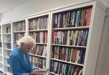 Janice, 97, reads in the center's newly refreshed library, which now features clean new bookshelves and a cozy feel. Photo courtesy Trout Creek Senior Center