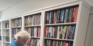 Janice, 97, reads in the center's newly refreshed library, which now features clean new bookshelves and a cozy feel. Photo courtesy Trout Creek Senior Center