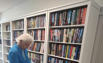 Janice, 97, reads in the center's newly refreshed library, which now features clean new bookshelves and a cozy feel. Photo courtesy Trout Creek Senior Center