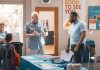 A member speaks with a First Coast YMCA staff member at a health and wellness table. Photo courtesy First Coast YMCA